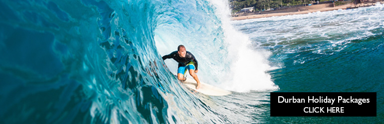 A view of a surfer surfing along Durban's Golden Mile.