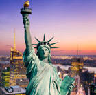 A view of the Statue of Liberty in New York at night, which can be visited via a cheap flight from Flight Centre.