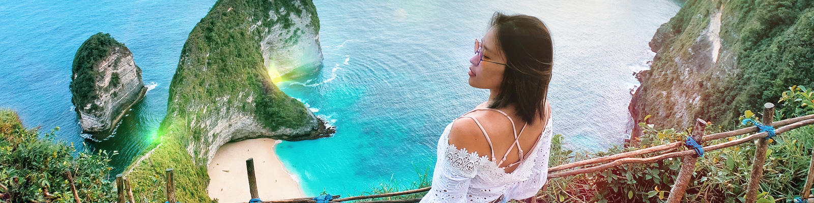 A woman looks across the sea on her Bali holiday, which she took via a cheap Bali Holiday package from Flight Centre.